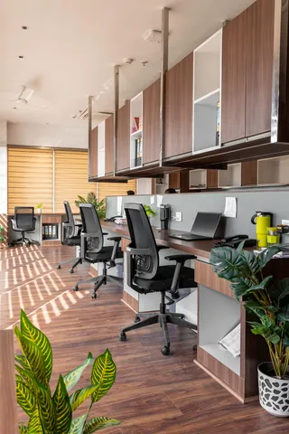 A café-style office with wooden shelves and pendant lights